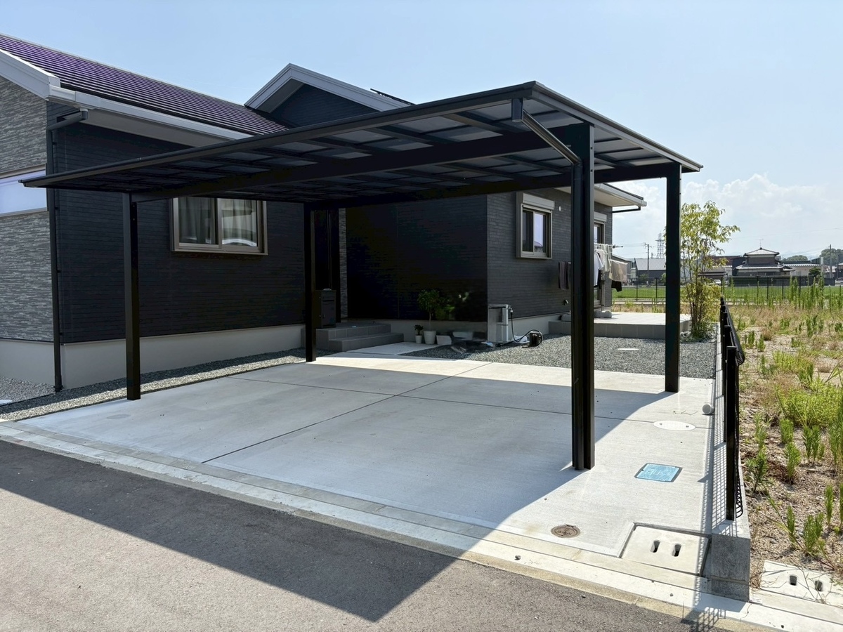 モノトーンで統一された機能美。黒のカーポートと広々コンクリートテラスが彩るモダン外構